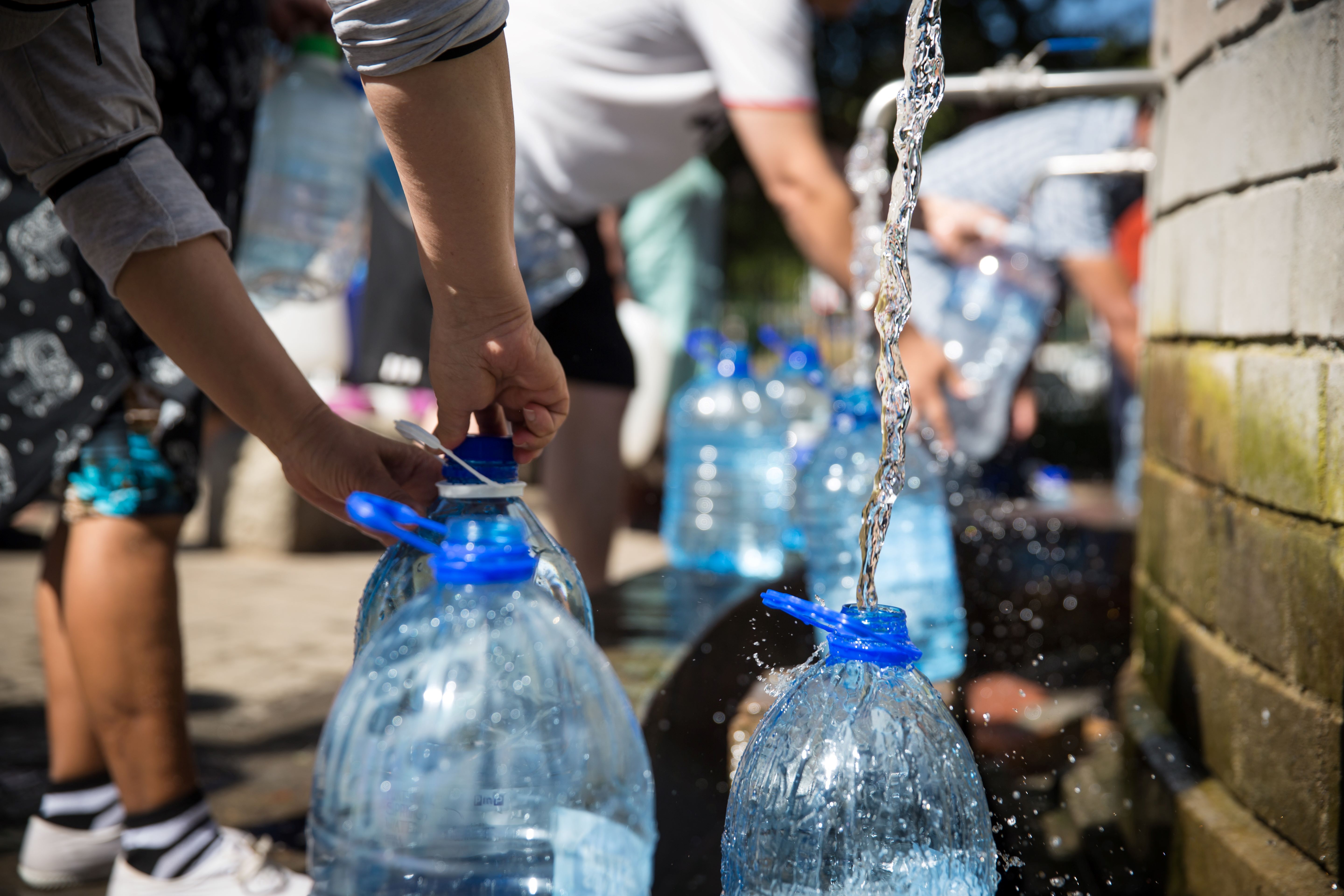 Photo of people filling up water bottles