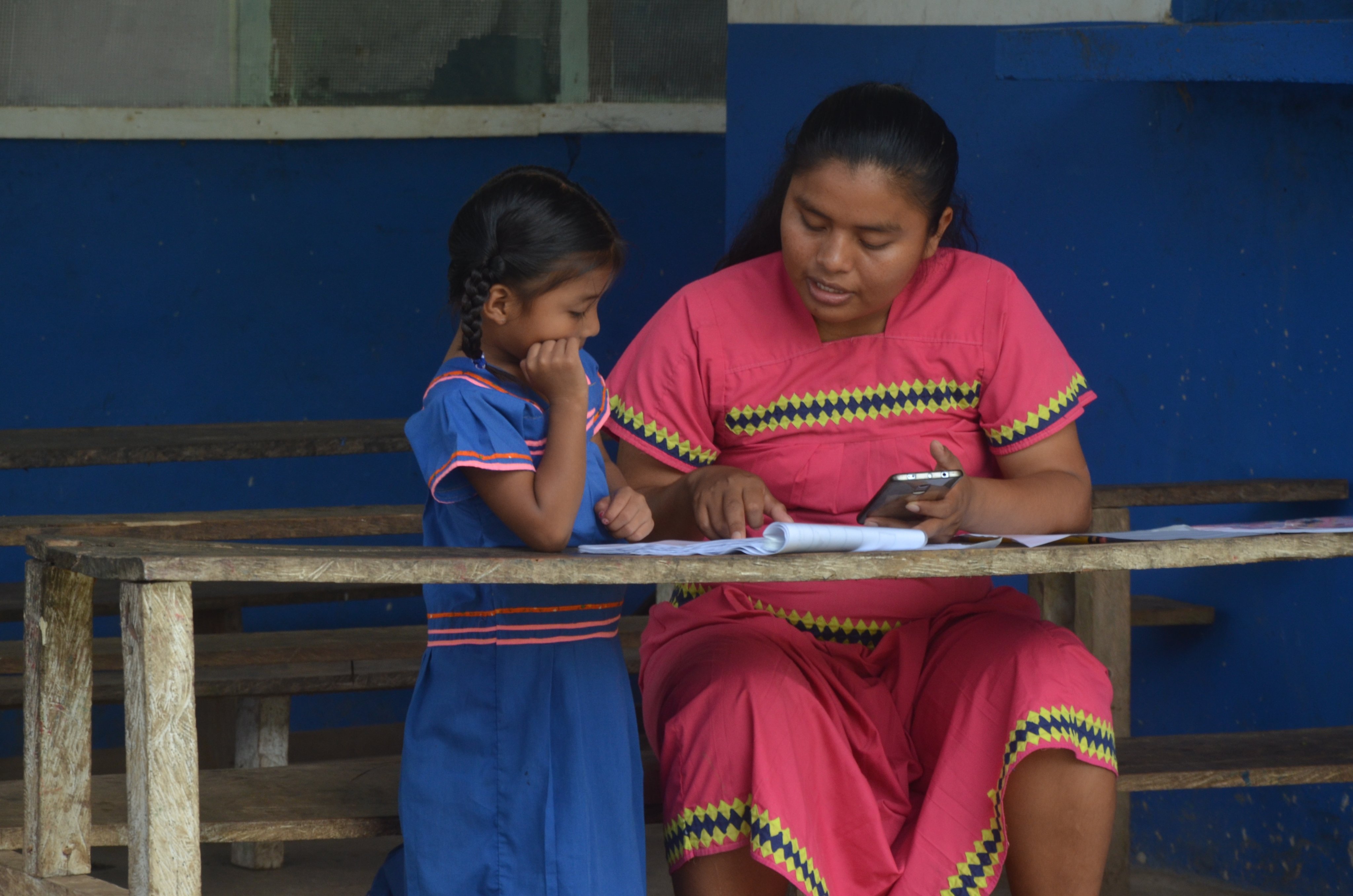Ngäbe interviewer administers a learning assessment to a Ngäbe community student