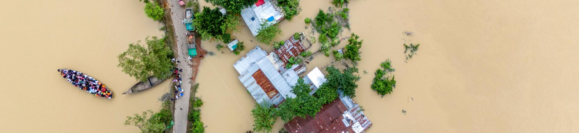 Village flooding in Bangladesh. reflecting this article's theme of climate adaptation.