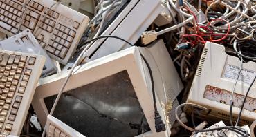 pile of electronic waste, reflecting this articles focus on the health impacts of e-waste