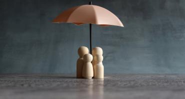 umbrella protecting family, reflecting focus of this article on protecting girls