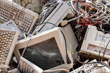 pile of electronic waste, reflecting this articles focus on the health impacts of e-waste