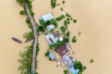 Village flooding in Bangladesh. reflecting this article's theme of climate adaptation.